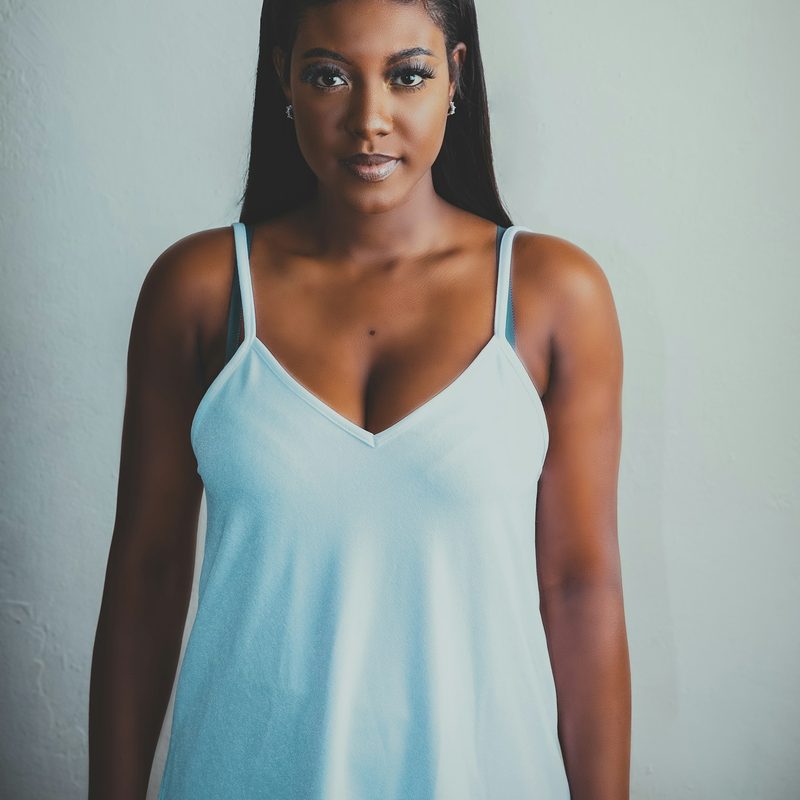 Woman in a light blue satin slip nightgown